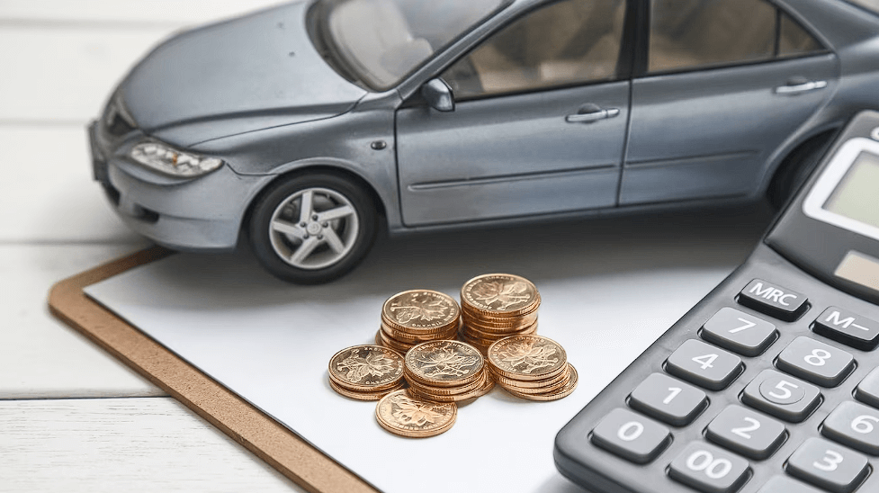 Car model, calculater and coins on white table