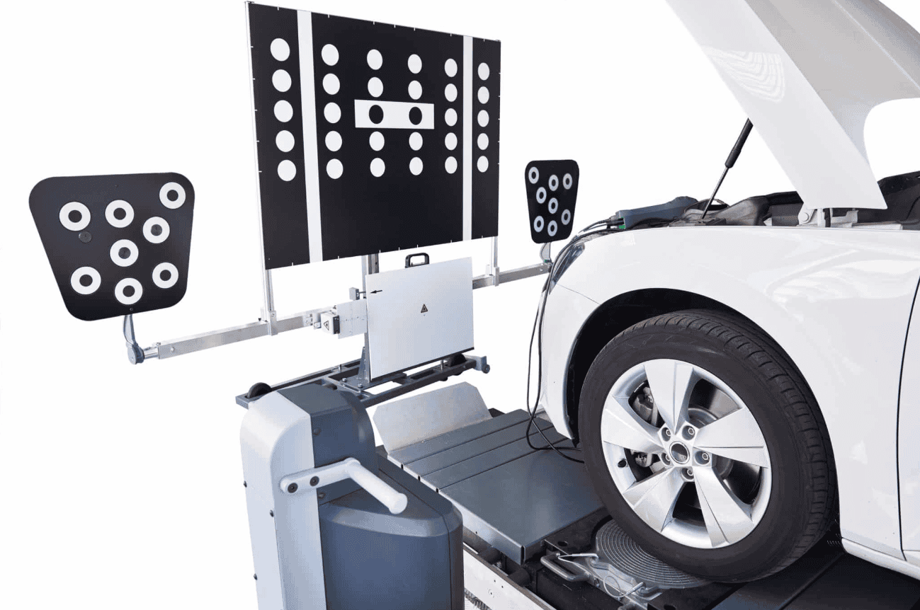 ADAS sensor calibration equipment positioned in front of a vehicle's wheel, illustrating post-accident recalibration needed for trucks and SUVs in Georgia