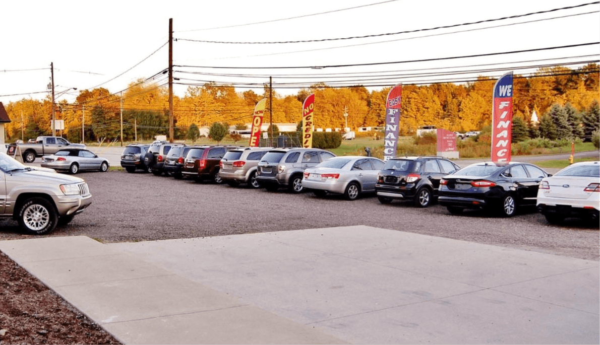 Used cars and SUVs lined up on a dealership lot as wholesale prices continue to fall in 2026