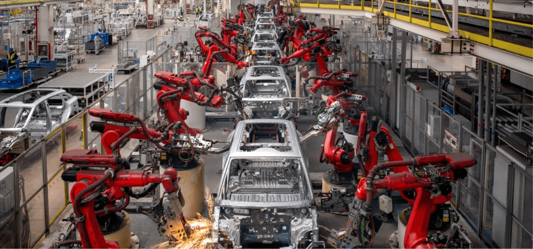 Robotic welding arms on a high-volume automotive assembly line, reflecting China's dominance in global vehicle production