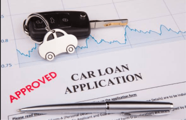 Approved car loan application and car keys, illustrating negative equity and diminished value for Carolina drivers