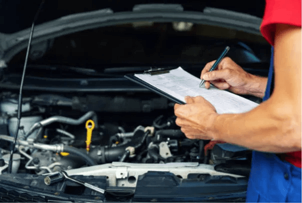 Technician recording vehicle condition and equipment under the hood for a Carolinas diminished value claim inspection